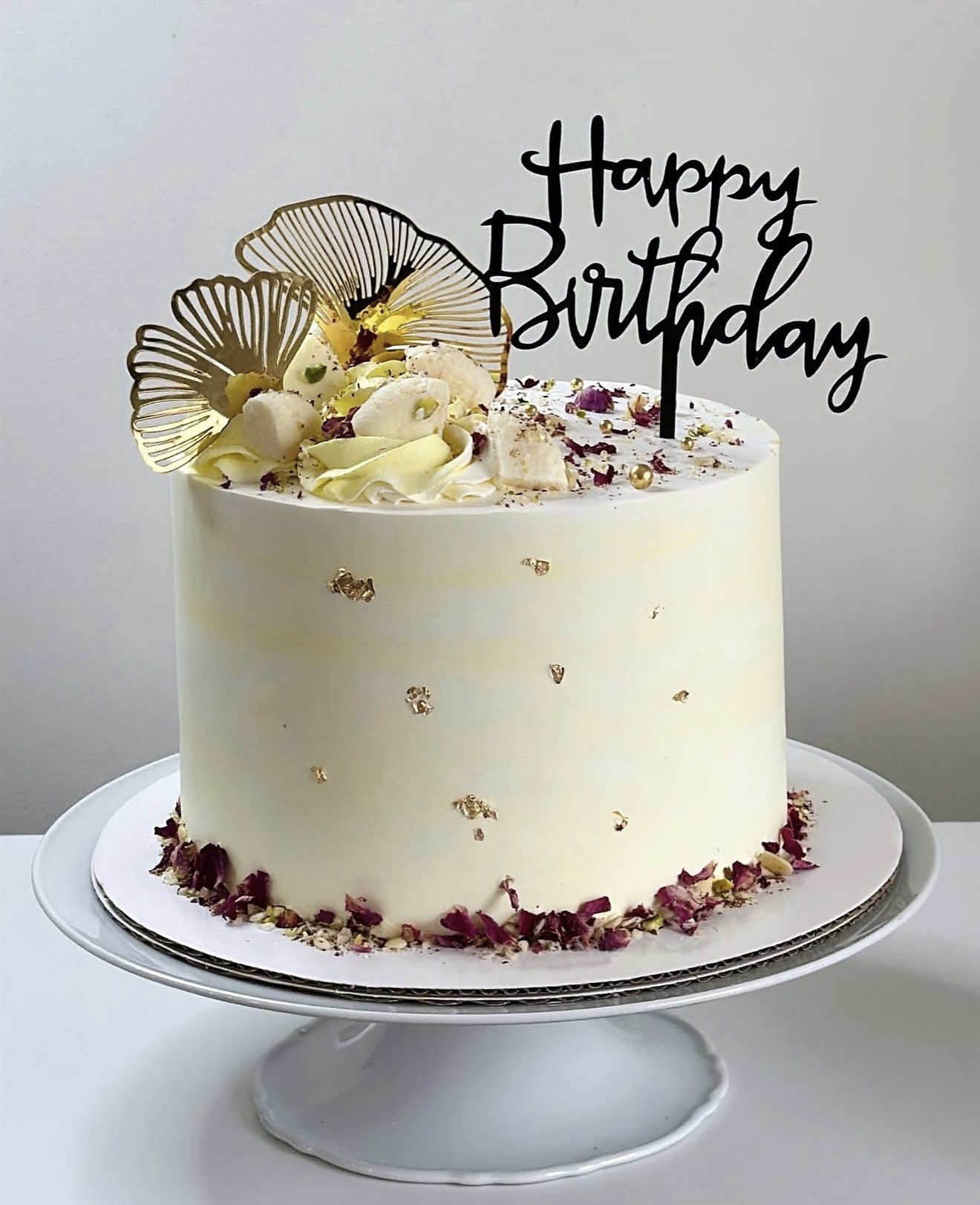 White birthday cake with baby's breath