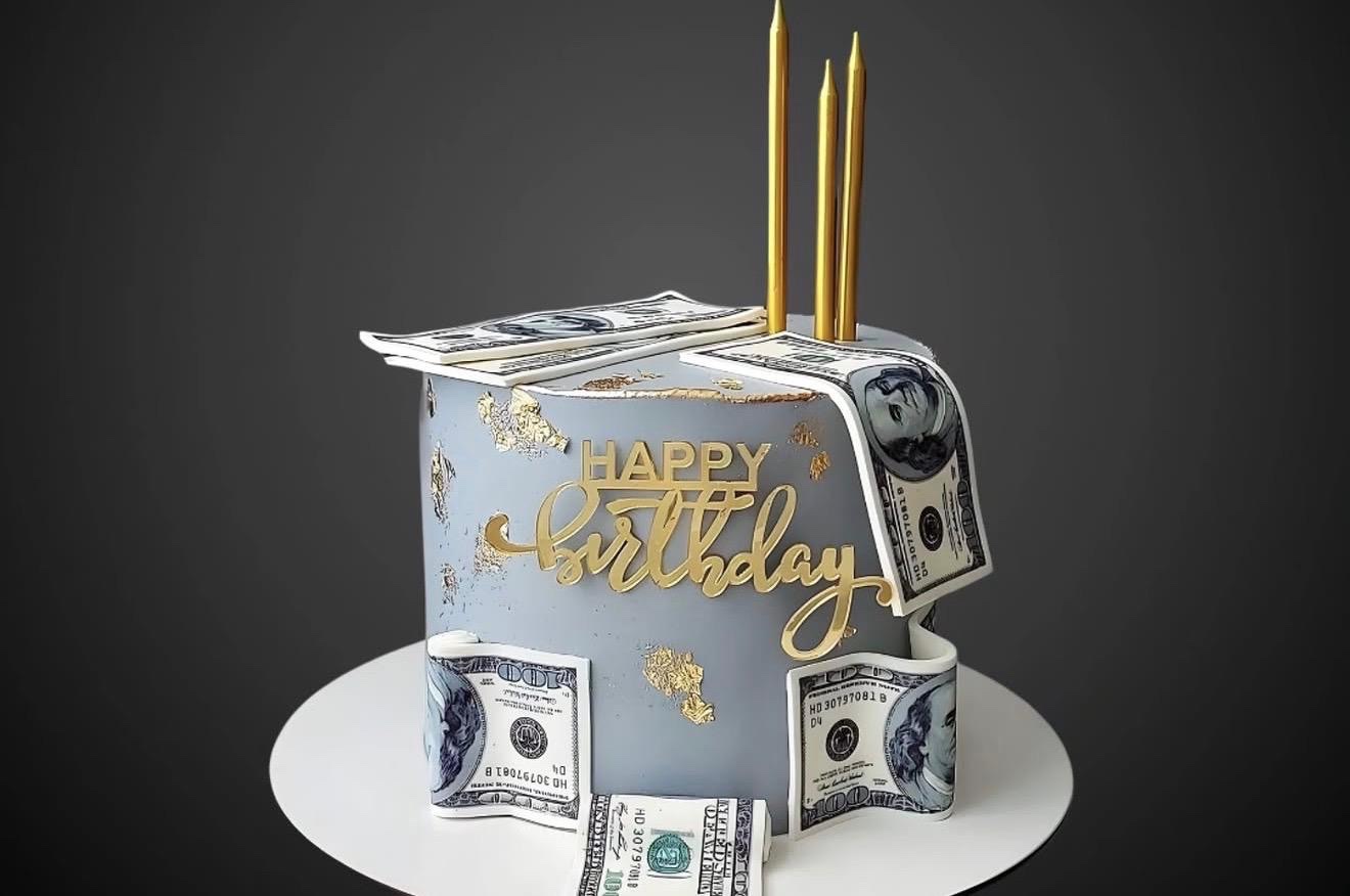 Money theme birthday cake with gold candles